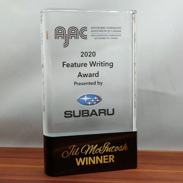 A custom-branded crystal corporate award sitting on a boardroom table.