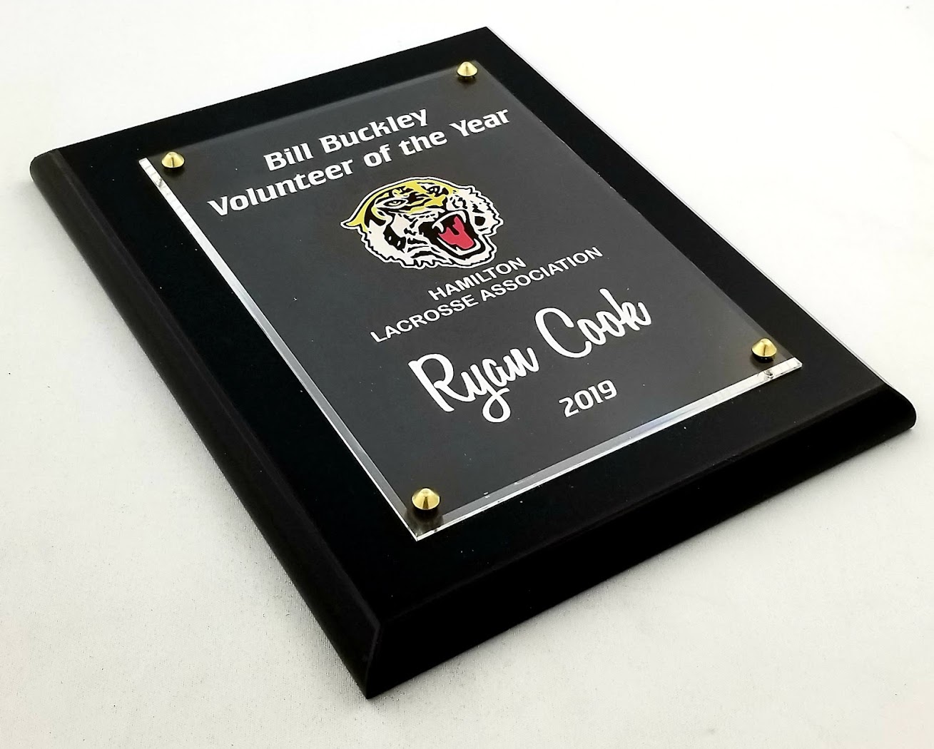 Formal black plaque showing serif-style lettering and engraved name plate from Aran Awards