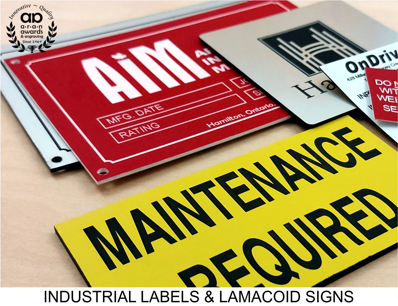 Industrial labels and lamacoid signs from Aran Awards & Engraving, featuring a variety of engraved and printed labels including maintenance and hazard signs, identification tags, and custom industrial plaques. Designed for durability and compliance in industrial settings.