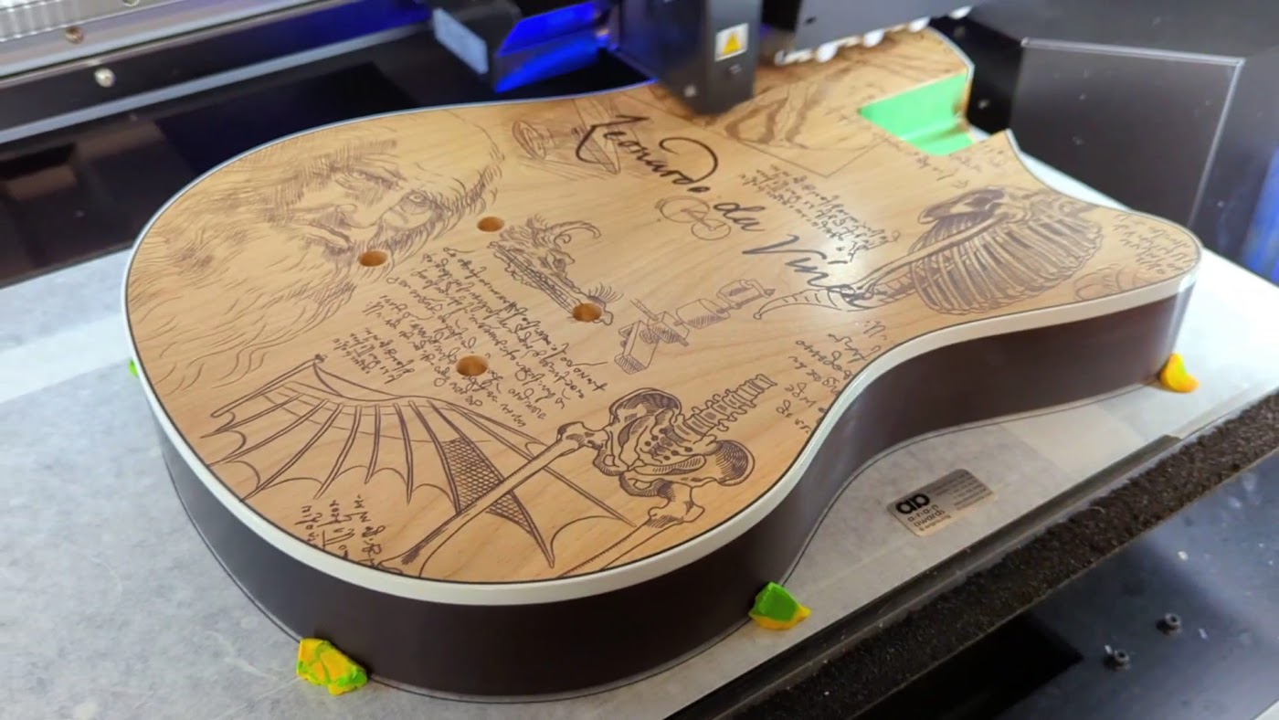 Laser engraving a custom wood board at Aran Awards in Hamilton