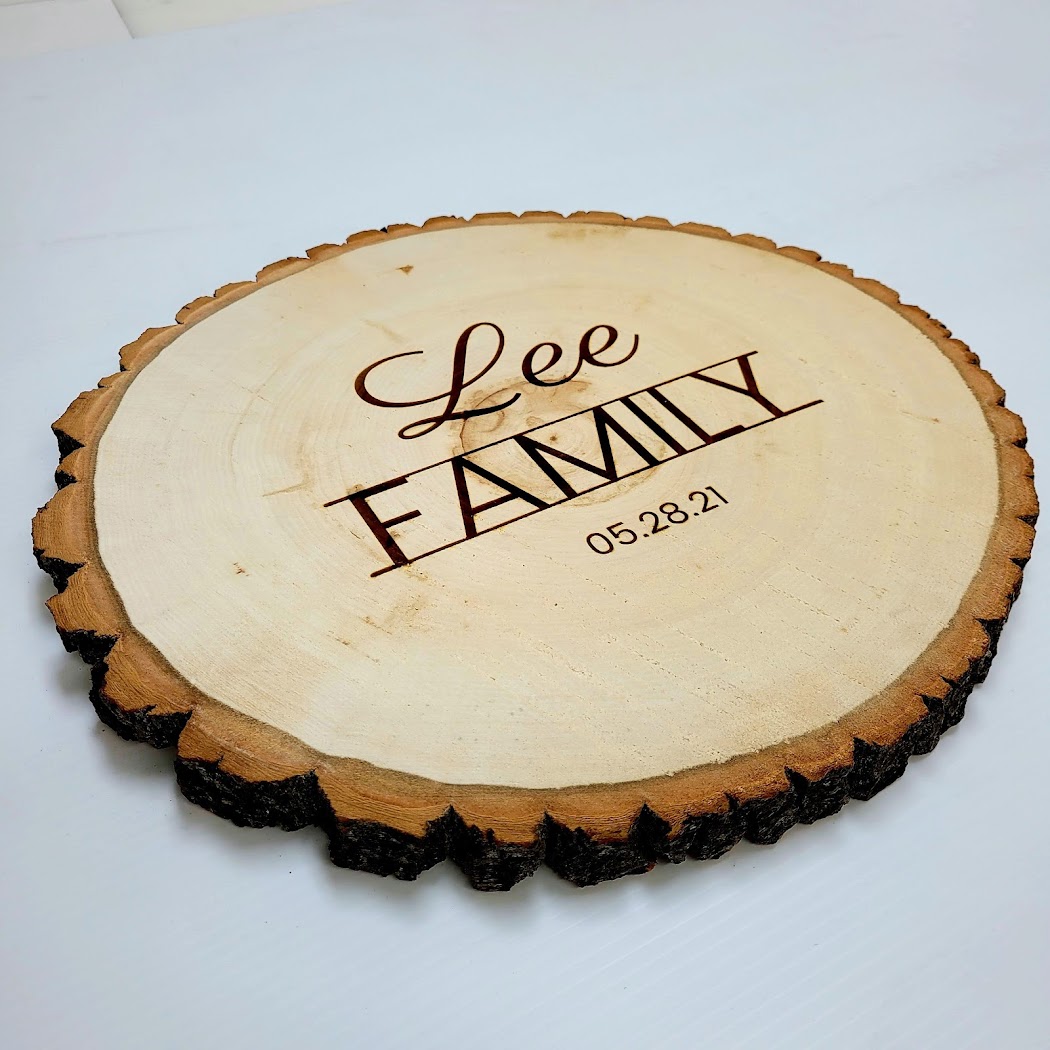 Wood slice engraving with script-style family name lettering